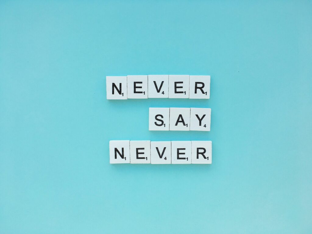 Never say never scrabble letters word on a blue background
